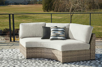 Calworth Outdoor Curved Loveseat with Cushion - Home And Beyond